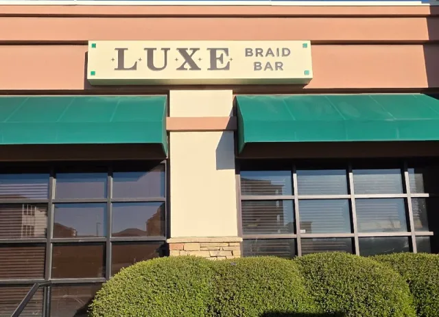 Luxe Braid Bar’s cabinet sign above its storefront.