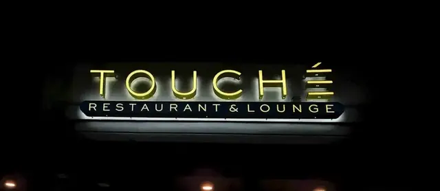 Touché illuminated storefront sign