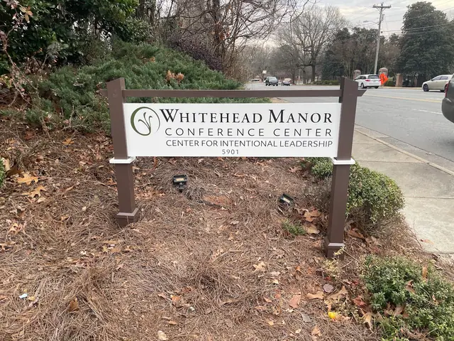 Whitehead Manor Conference Center roadside sign beside a landscaped approach.